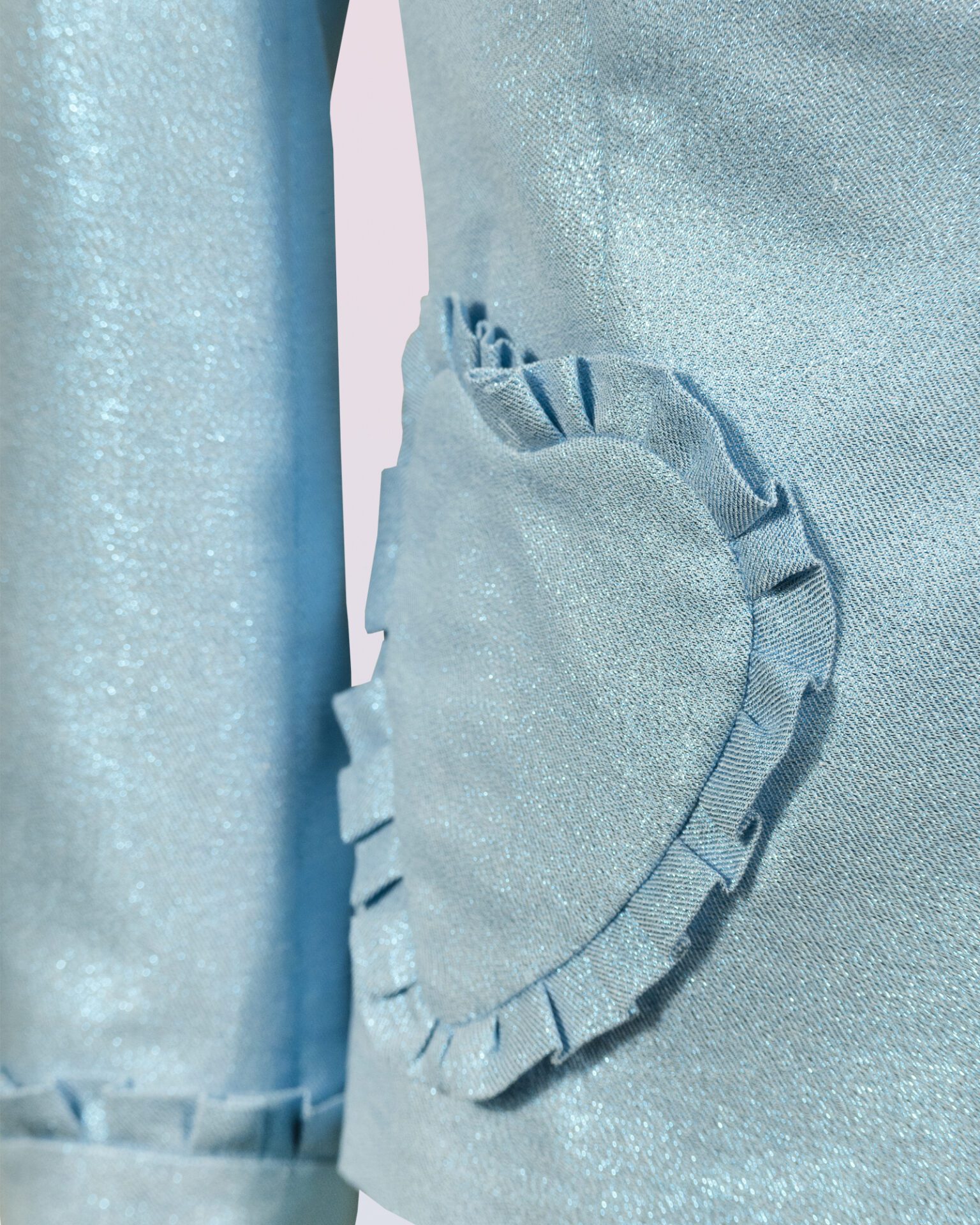 The fitted two-button jacket is made of iridescent linen/cotton blended fabric with metallic yarn