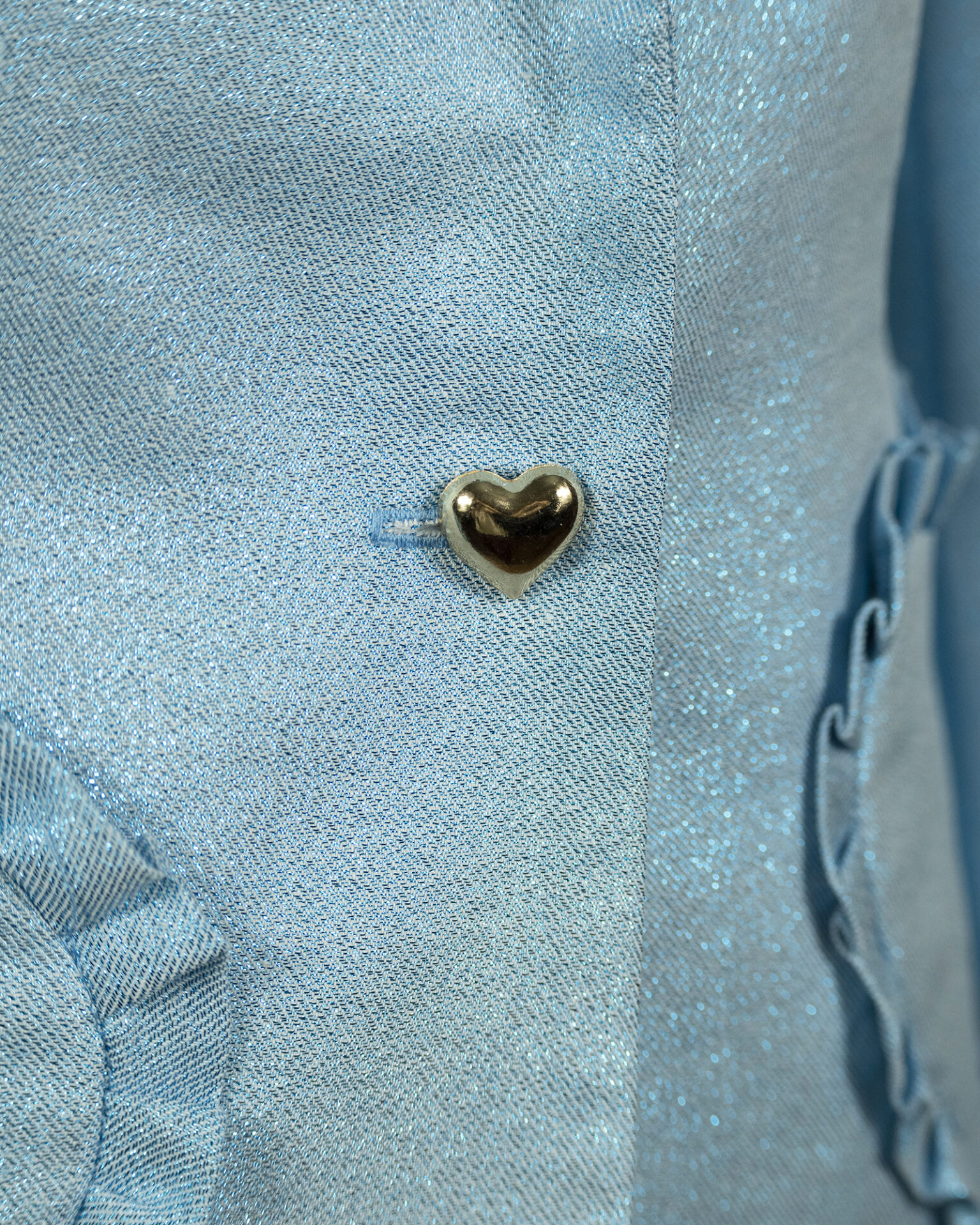 The fitted two-button jacket is made of iridescent linen/cotton blended fabric with metallic yarn