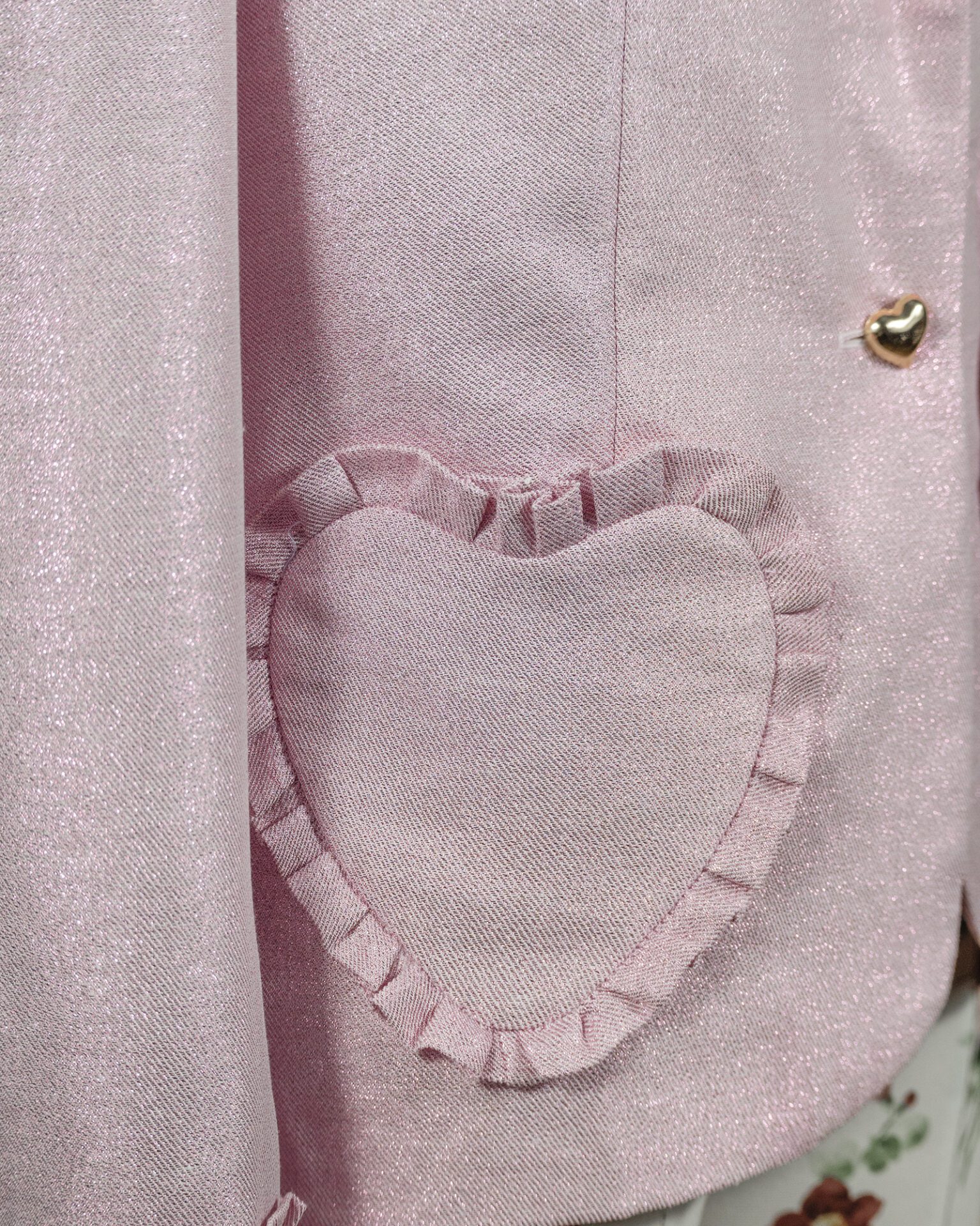 The fitted two-button jacket is made of iridescent linen/cotton blended fabric with metallic yarn