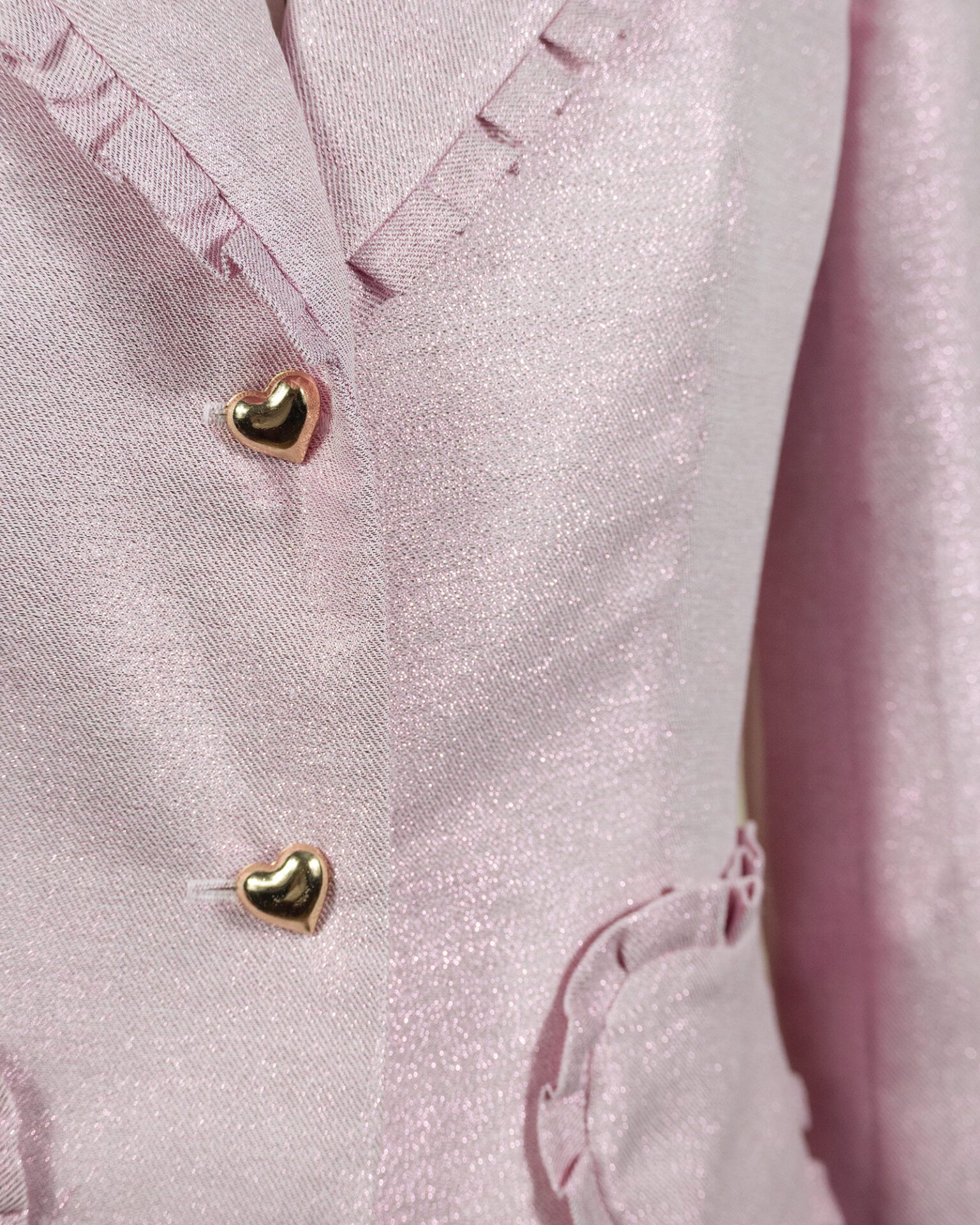 The fitted two-button jacket is made of iridescent linen/cotton blended fabric with metallic yarn