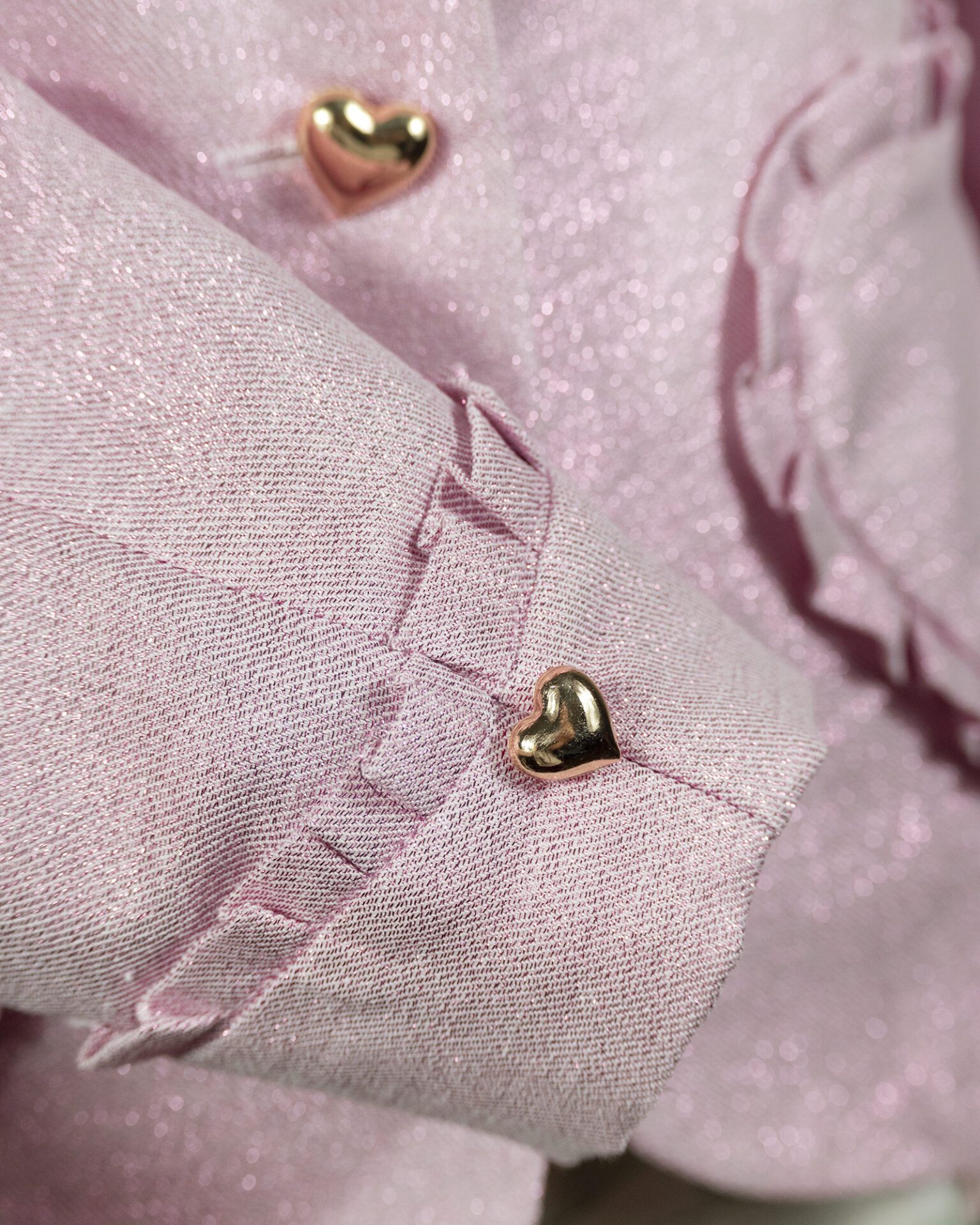 The fitted two-button jacket is made of iridescent linen/cotton blended fabric with metallic yarn