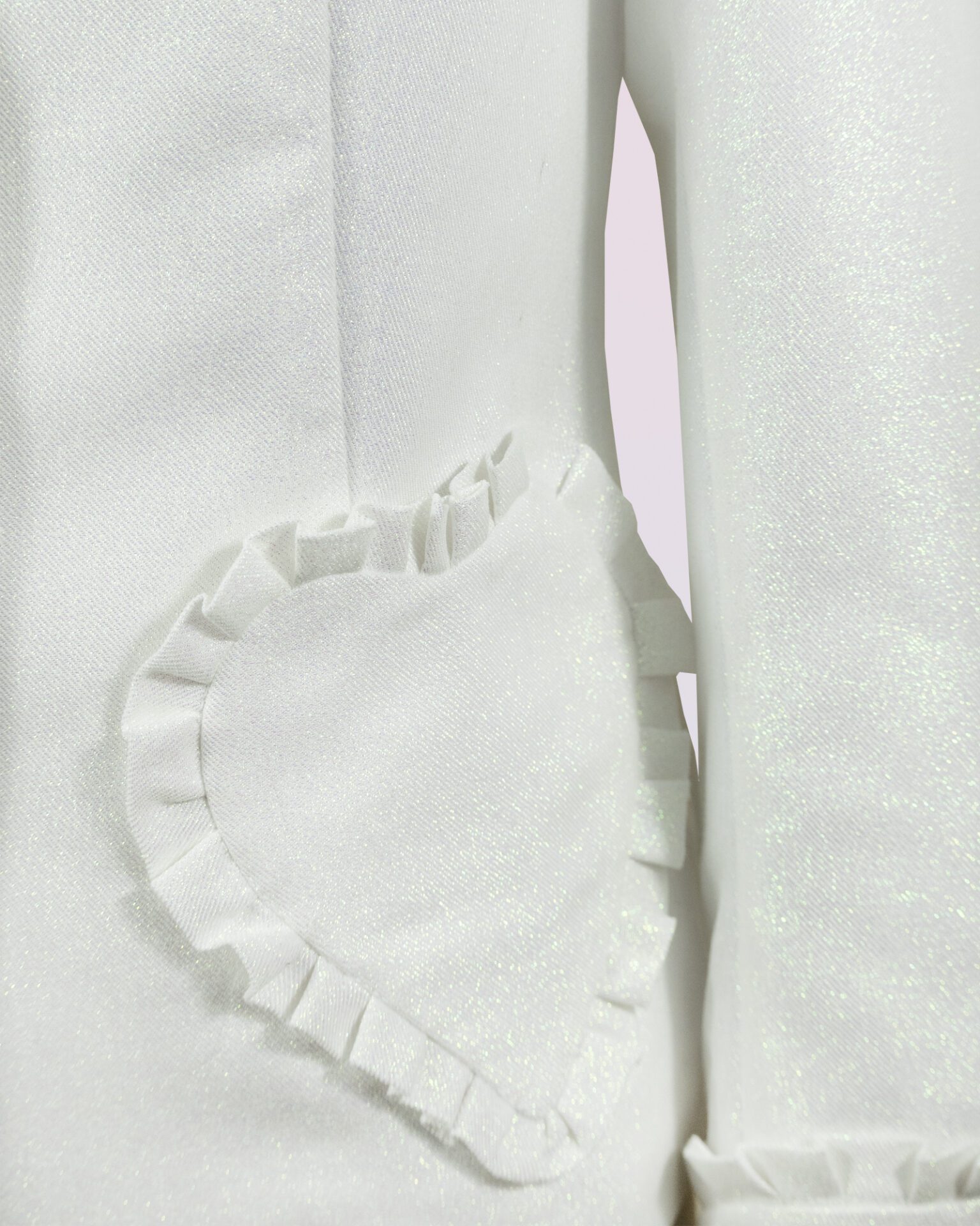The fitted two-button jacket is made of iridescent linen/cotton blended fabric with metallic yarn