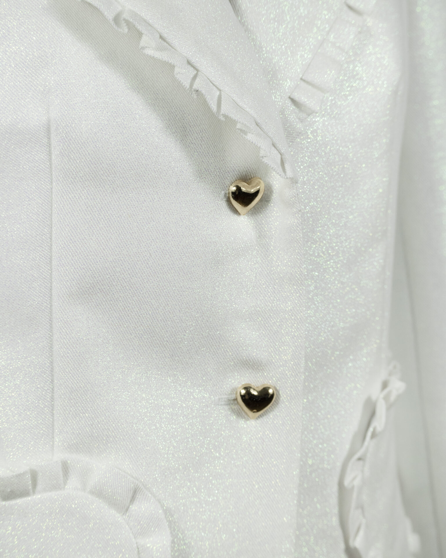 The fitted two-button jacket is made of iridescent linen/cotton blended fabric with metallic yarn
