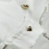 The fitted two-button jacket is made of iridescent linen/cotton blended fabric with metallic yarn