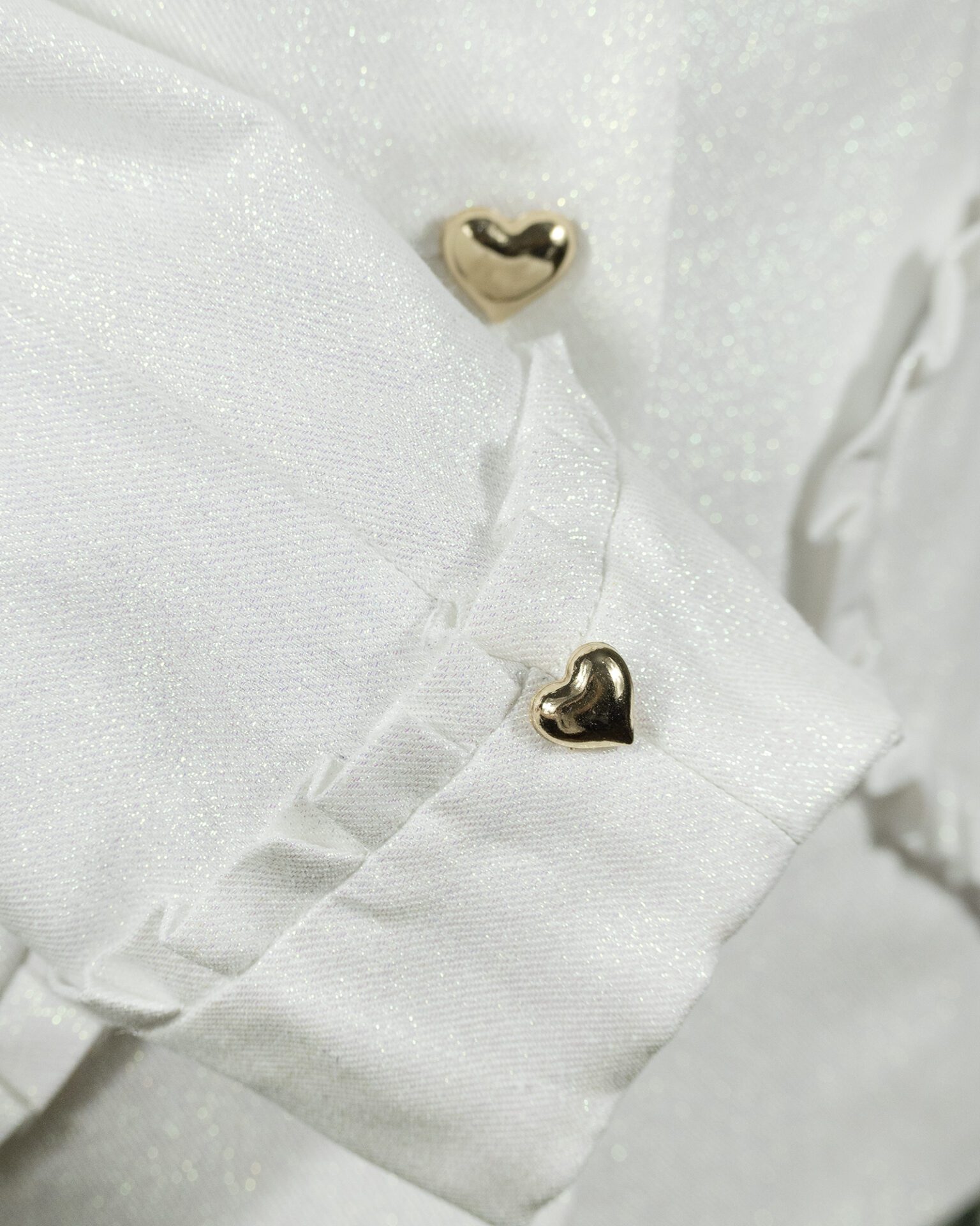 The fitted two-button jacket is made of iridescent linen/cotton blended fabric with metallic yarn